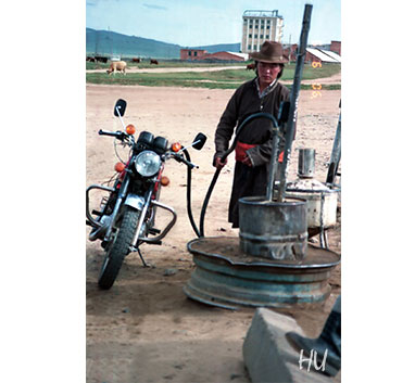 Gas station and young motorcycle rider, Mongolia, 1990.  Photography by Halil Uğur